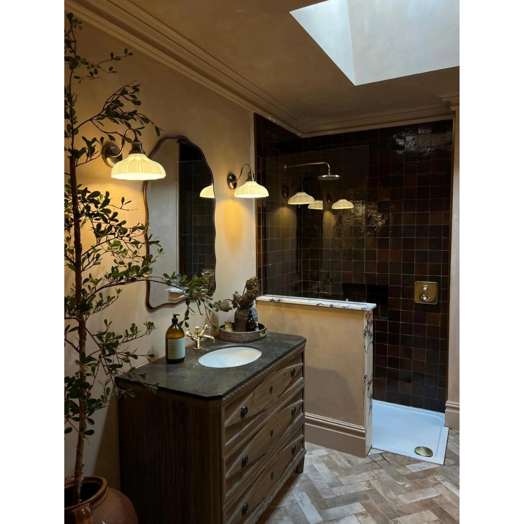 Oak zellige tiles in a glossy dark brown shower wall with a vintage vanity